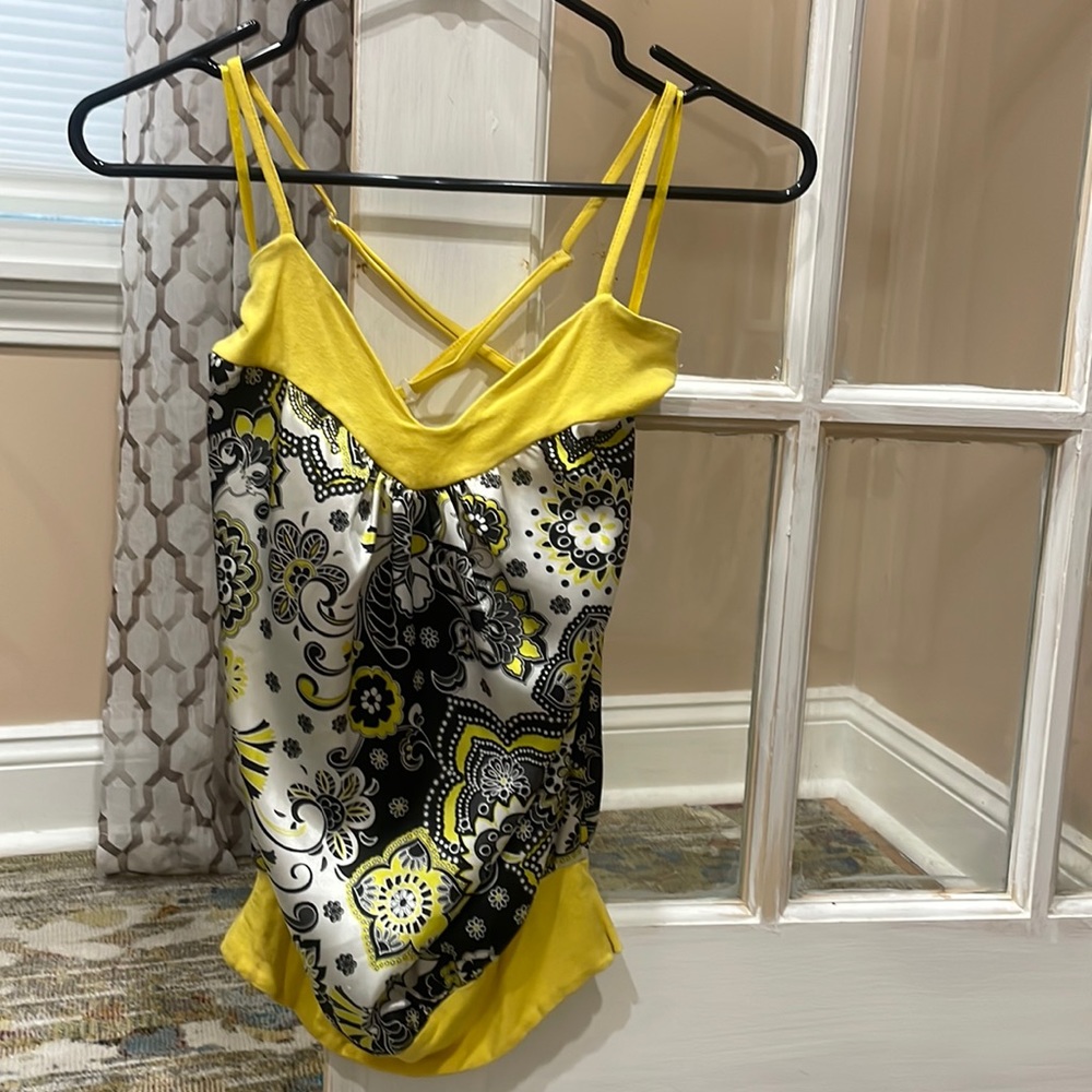 Yellow and black camisole with adjustable straps that cross into a X in the back